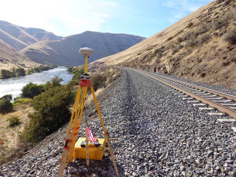 Surveying equipment setup on train tracks